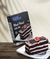 Box of Crust & Crumb Black Forest Cake Mix with a slice of cake on a plate.