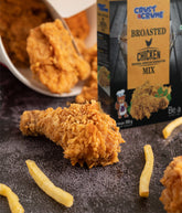 Fried chicken pieces with a box of Crust & Crumb broasted chicken mix on a dark surface.