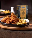 Fried chicken and fries on a plate with a box of crust n crumb chicken mix in the background.