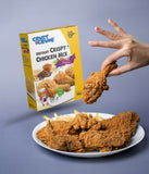 Crust & Crumb crispy chicken mix seasoning on a plate with a hand holding a piece of chicken.