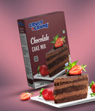Crust N Crumb Chocolate cake mix box with a slice of chocolate cake on a white plate against a pink background