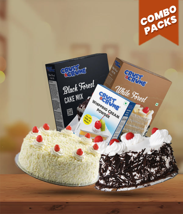 Two black forest cake slices with Crust & Crumb cake mix combo and whipping cream powder packaging on a wooden surface.