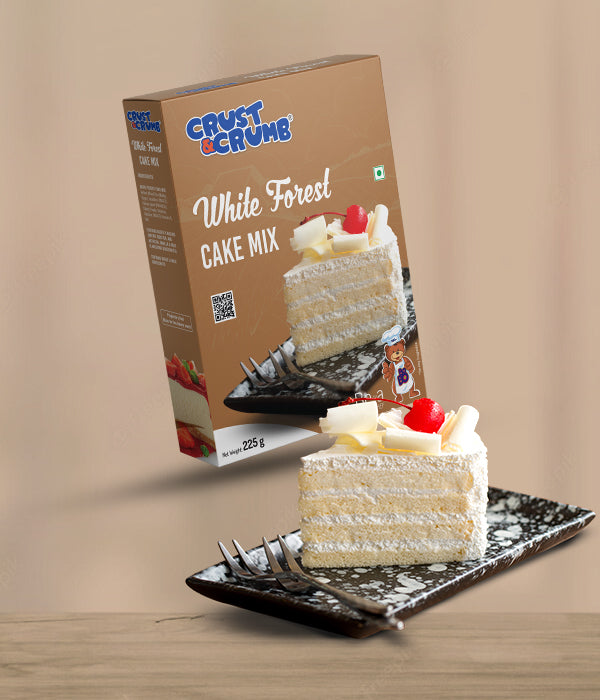 Crust & Crumb White Forest Cake Mix packaging with a slice of cake on a plate against a beige background